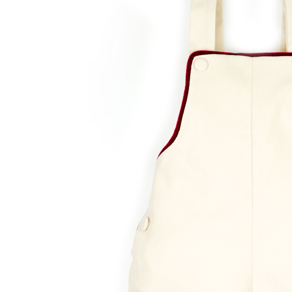 Salopette in velluto panna con profilo rosso